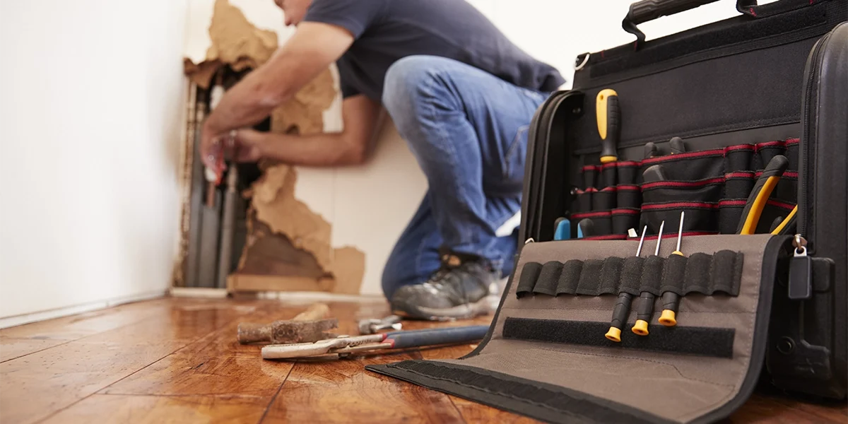 middle-aged-man-repairing-burst-pipe-plumbing-foc-2024-10-21-18-59-22-utc copy middle-aged-man-repairing-burst-pipe-plumbing