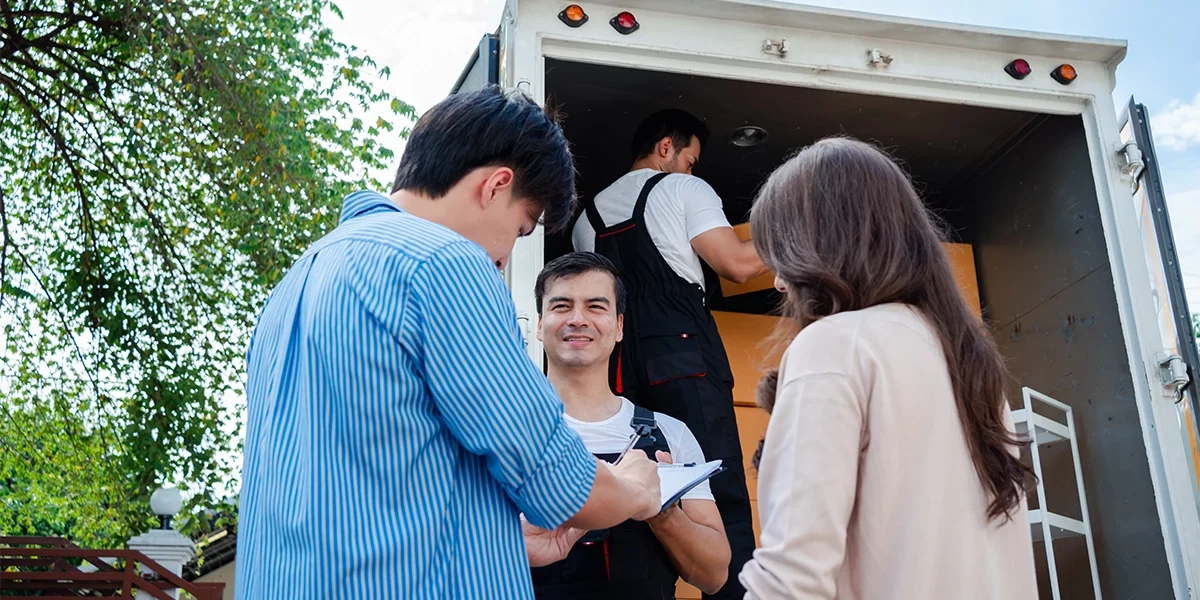 asian-couple-check-while-unloading-boxes-and-furni