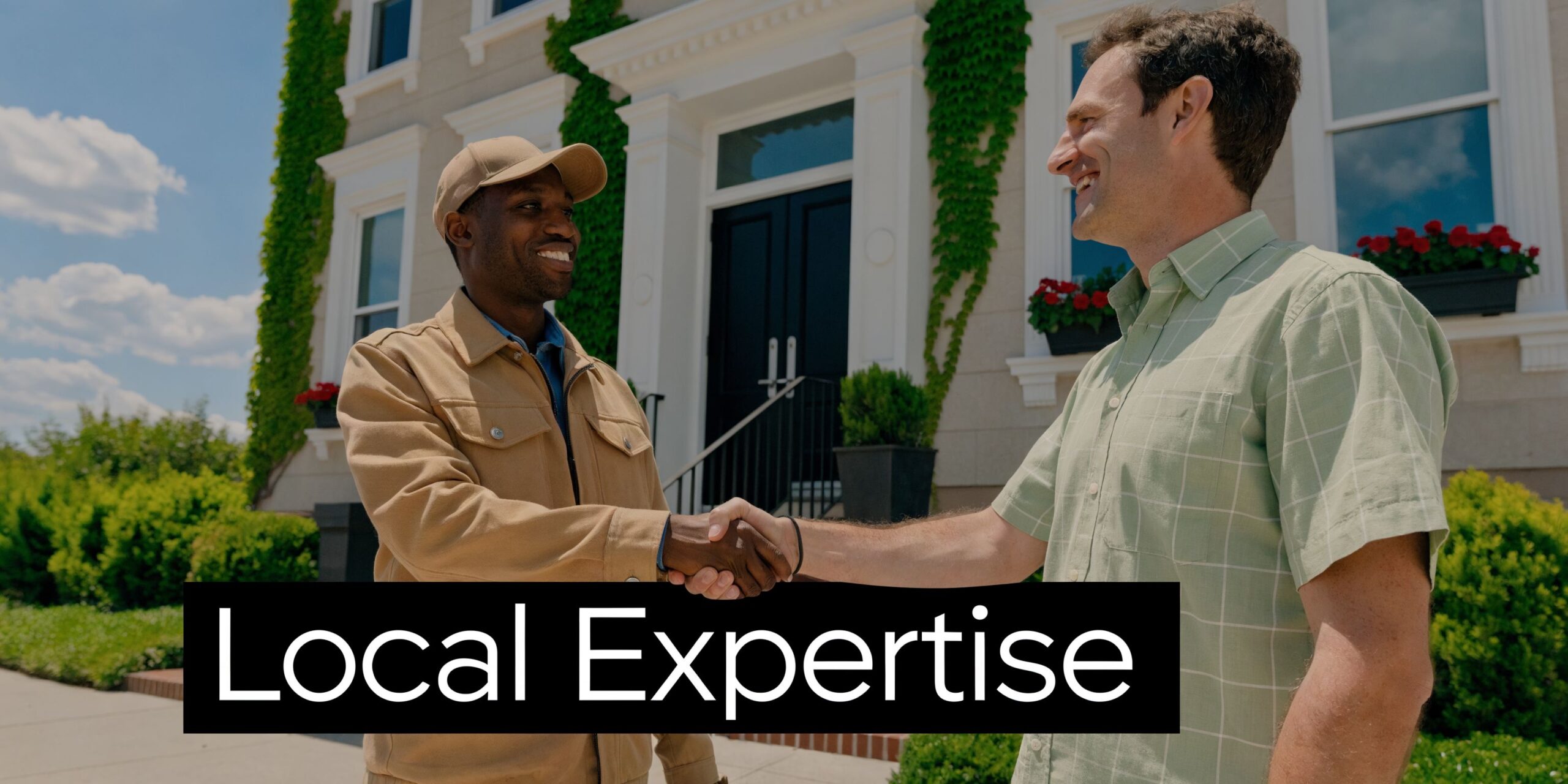 A professional property manager shaking hands with a happy client in front of a beautiful residential home.