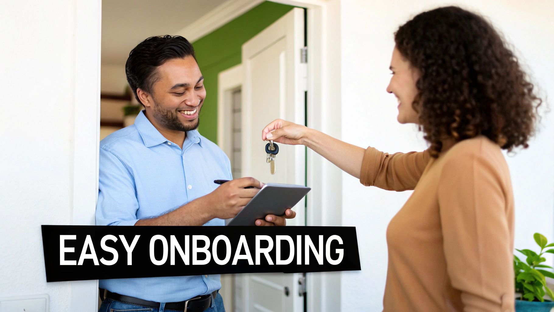 A smiling man and woman exchanging house keys and signing documents at a home entrance.