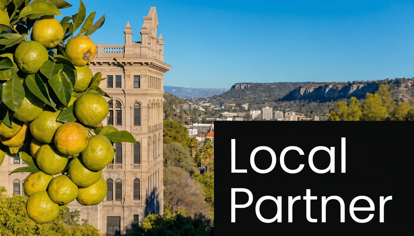 A scenic view of a historic building in Redlands with citrus fruit in the foreground.