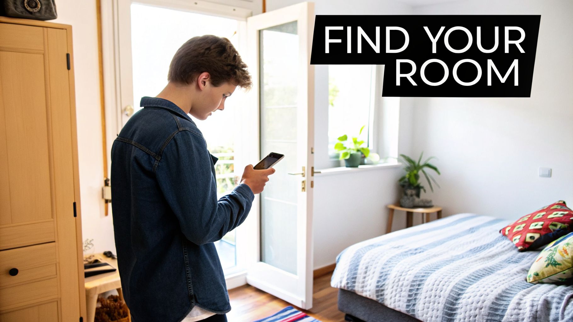 A young person checks their phone while standing in a bright bedroom with a bed and window.